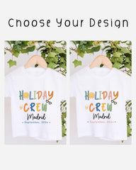 two white t-shirts with colorful text and graphics, hanging on a wooden hanger. The text on the t-shirts reads "HOLIDAY CREW Madrid" and "September, 20xx".
