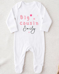A white onesie with the text "Big Cousin Emily" printed on it.
