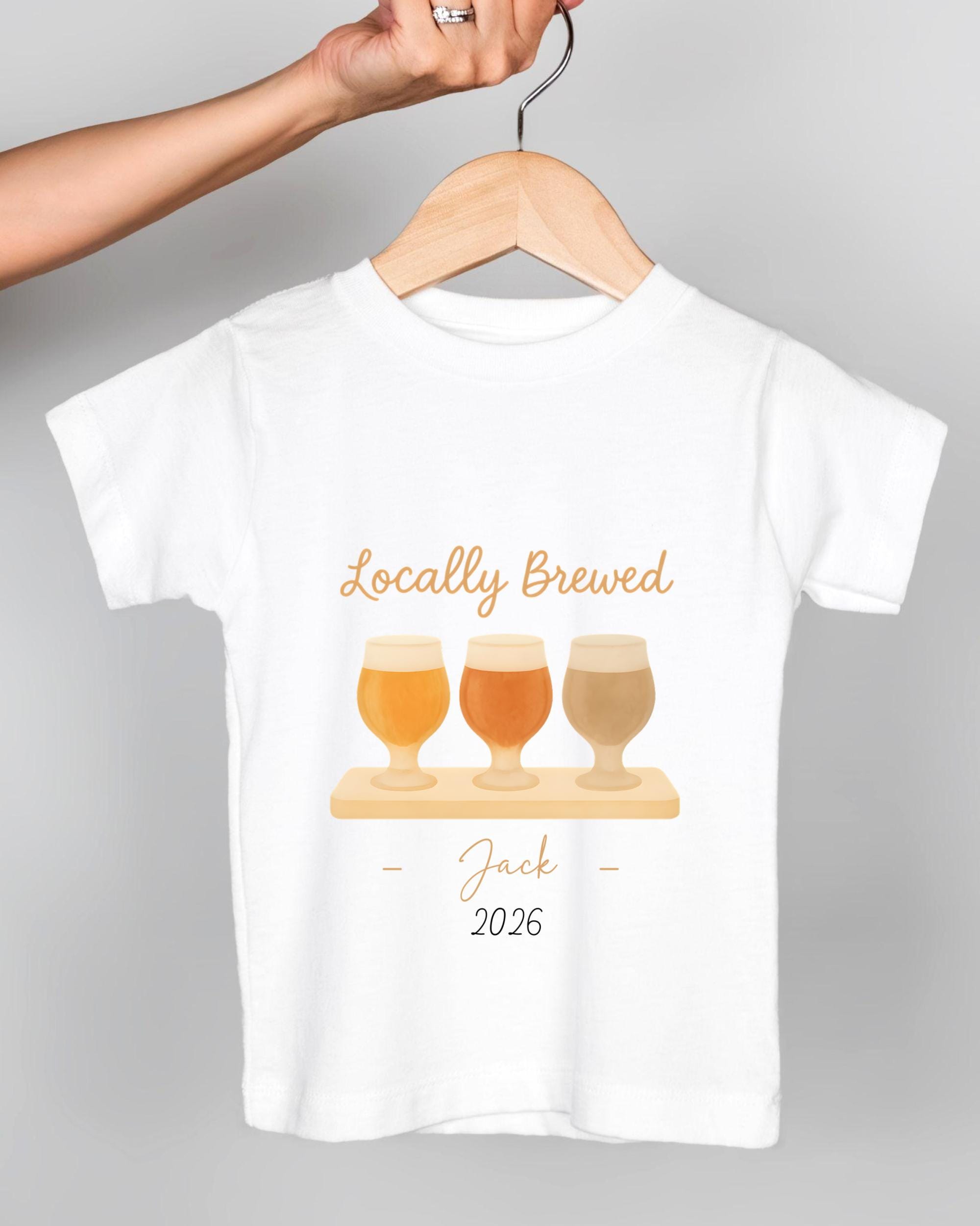 A white t-shirt with a graphic design featuring three beer glasses and the text "Locally Brewed Jack 2026".
