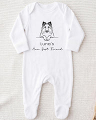 A white onesie with a black graphic of a dog and the text "Luna's New Best Friend" printed on it.