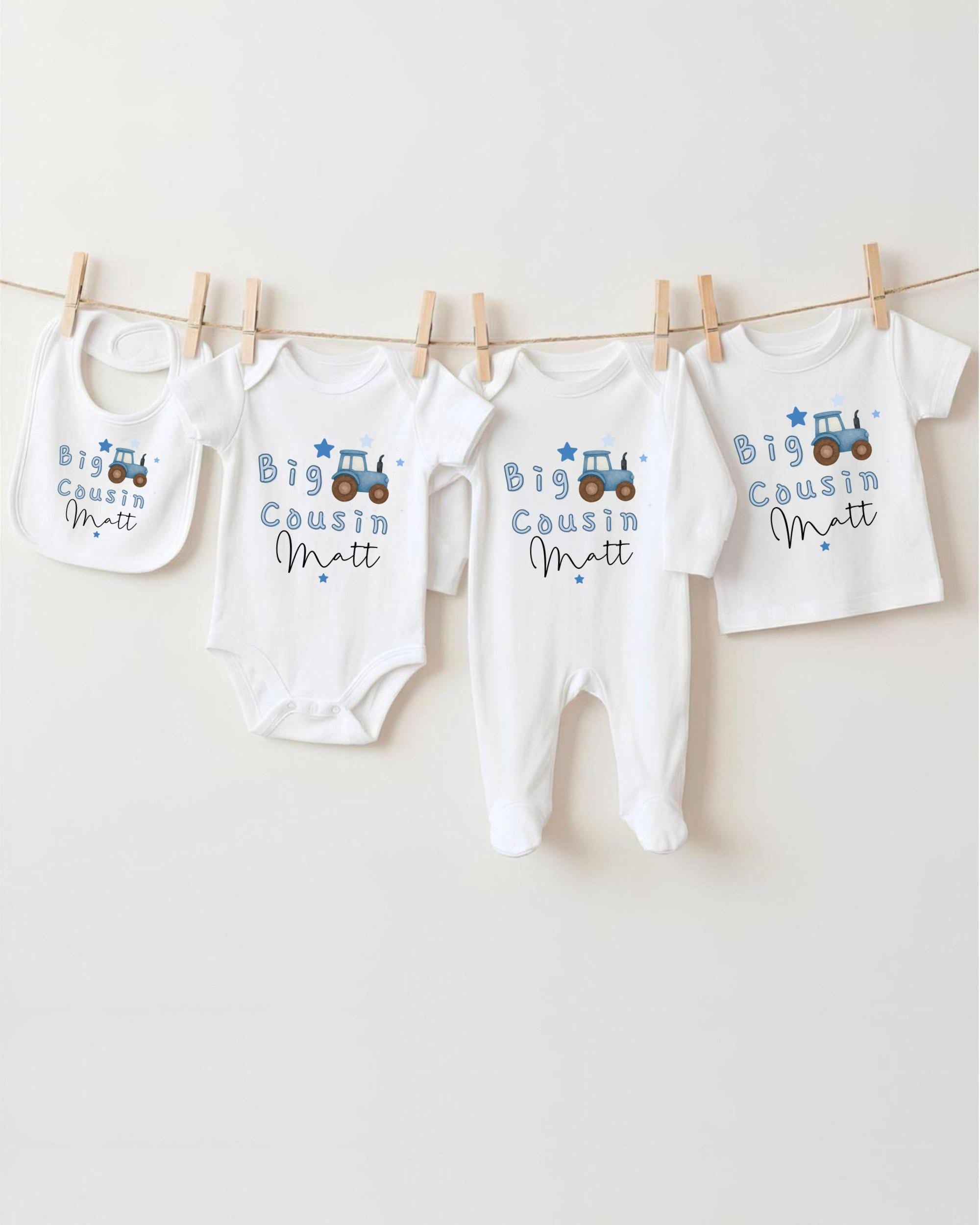 A collection of baby clothes, including onesies and bibs, hanging on a clothesline.