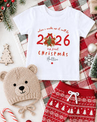 a white t-shirt with a Christmas-themed design, a beige knit hat, red and white patterned shorts, and various Christmas decorations such as a Christmas tree, ornaments, and a snowflake.