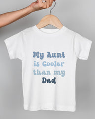 A white t-shirt with text printed on it, hanging on a wooden hanger.
