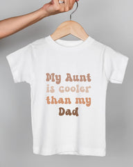 A white t-shirt with text printed on it, hanging on a wooden hanger.