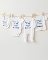 a row of four white baby clothes hanging on a clothesline, each with a different message printed on it.