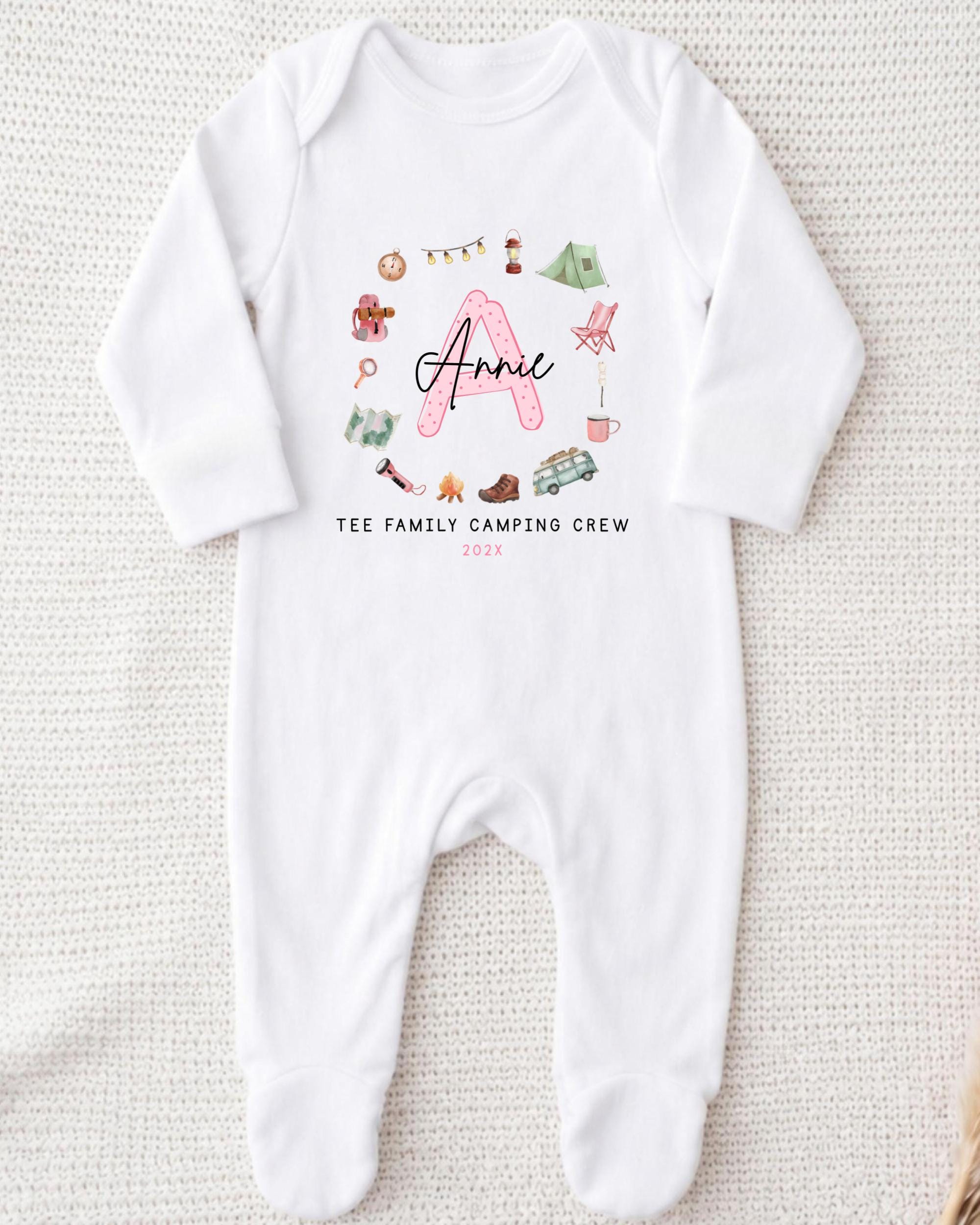 A white onesie with a personalized name and camping crew printed on it.