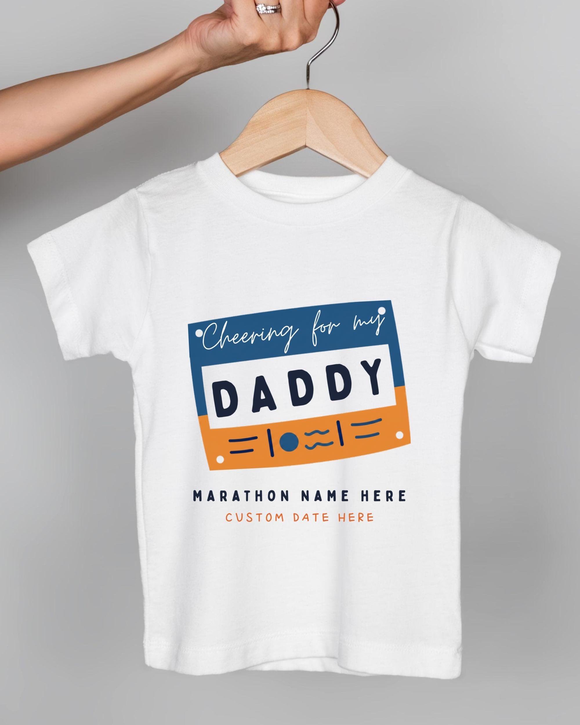 A white t-shirt with a graphic design featuring a blue and orange rectangle with the text "Cheering for my DADDY" and "Marathon Name Here Custom Date Here" printed on it.