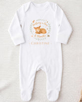 A white onesie with a graphic of a baby deer and text that reads "Halfway to One 6 Months - Christine".