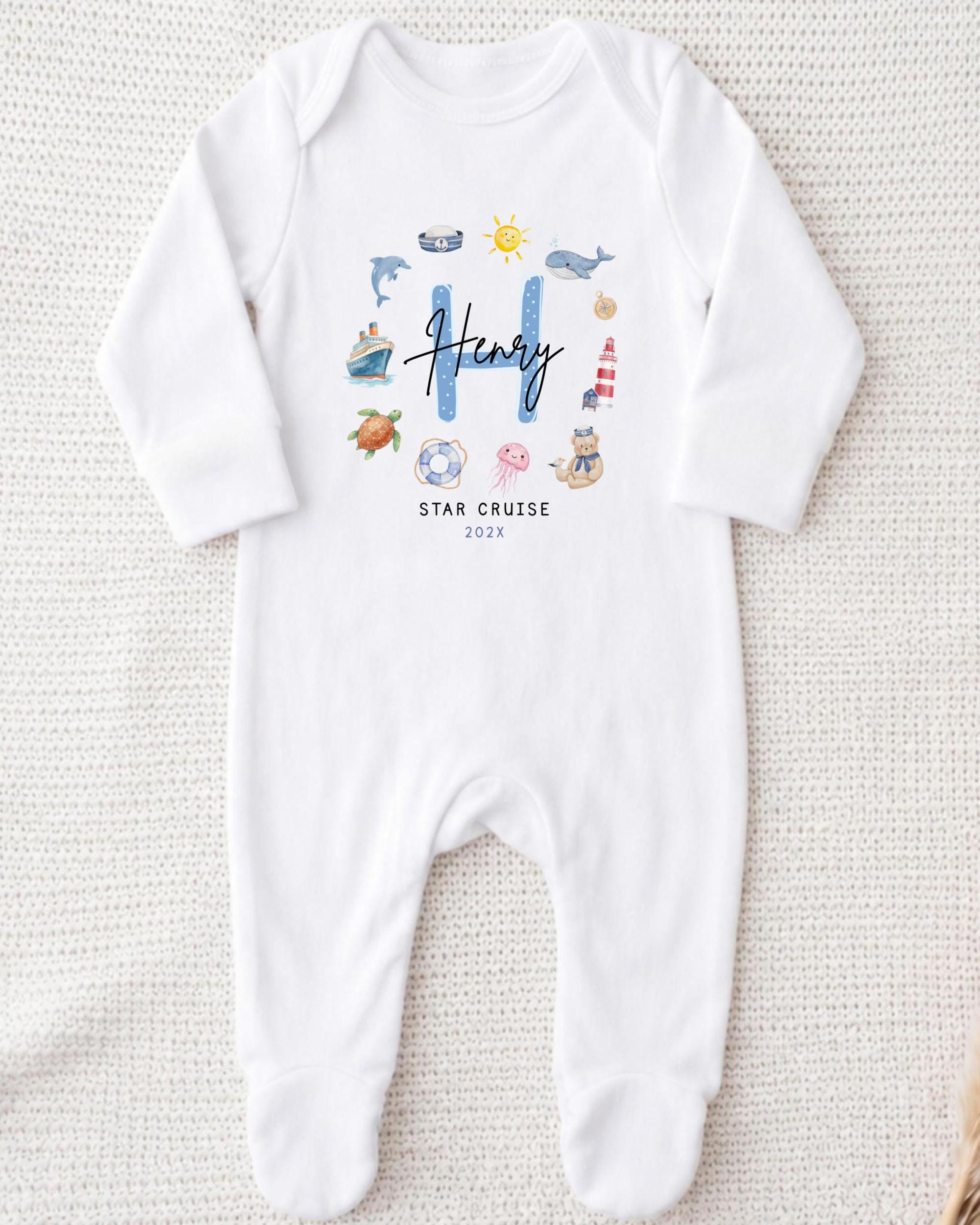 A white onesie with a personalized name and a "STAR CRUISE" text printed on it.