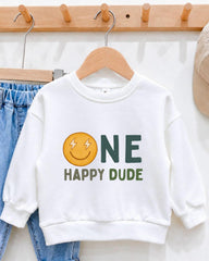 A white sweatshirt with a graphic design and text printed on it, hanging on a wooden hanger.