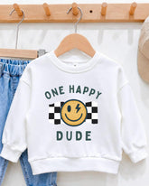 A white sweatshirt with a graphic design and text printed on it, hanging on a wooden hanger.