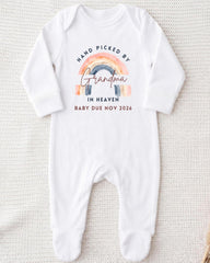 A white onesie with a graphic design and text on it.