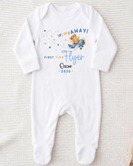 A white onesie with a cartoon airplane and text printed on it.