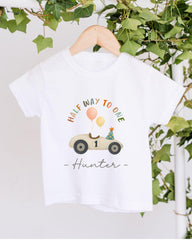 A white t-shirt with a graphic design of a car and balloons, along with the text "Half Way to One Hunter" printed on it.