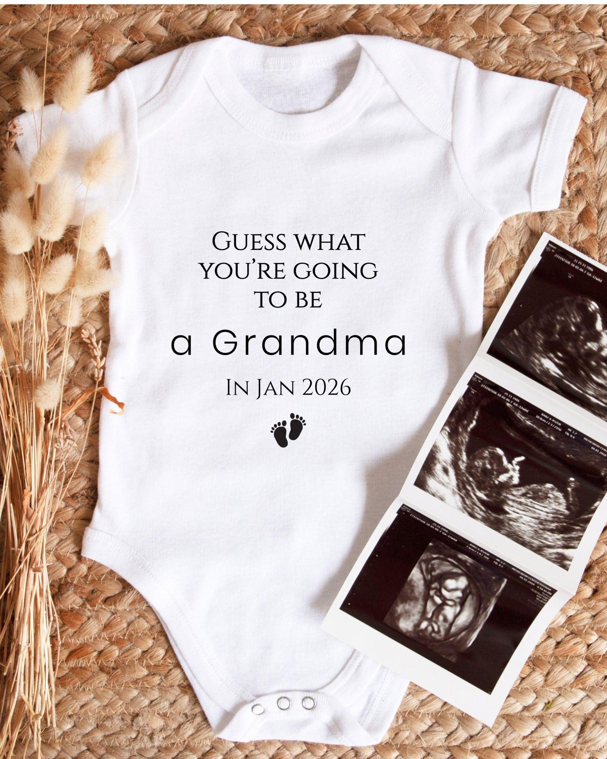 A white baby onesie with text and a graphic of baby footprints, along with a photo of an Ultrasound image, suggesting a pregnancy announcement.