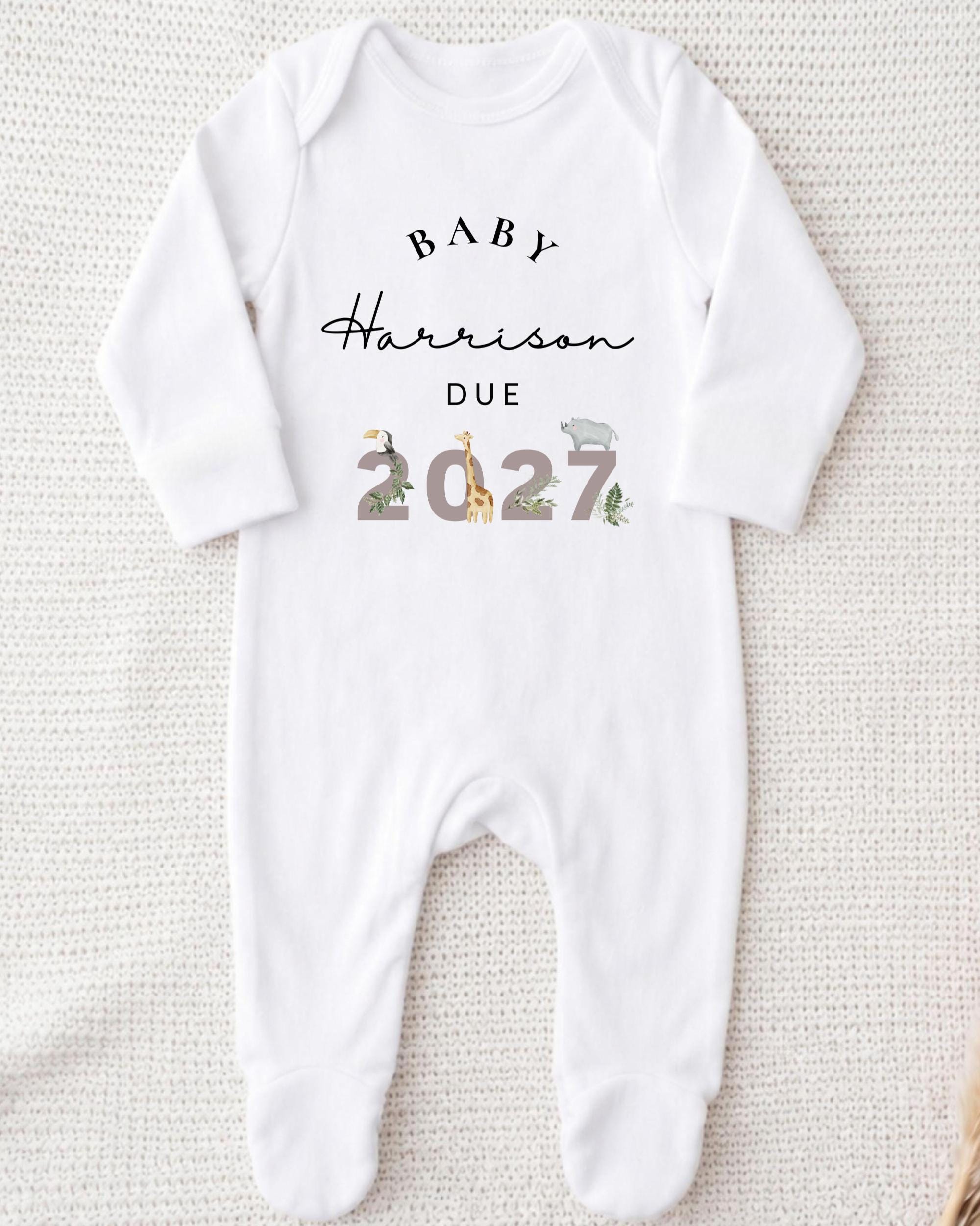 A white onesie with text and illustrations on it.