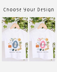 two white t-shirts with personalized designs, hanging on a wooden hanger. The designs include a blue airplane, a pink airplane, a suitcase, a palm tree, and a sun. The text on the t-shirts reads "Olivia Barcelona July 2026".