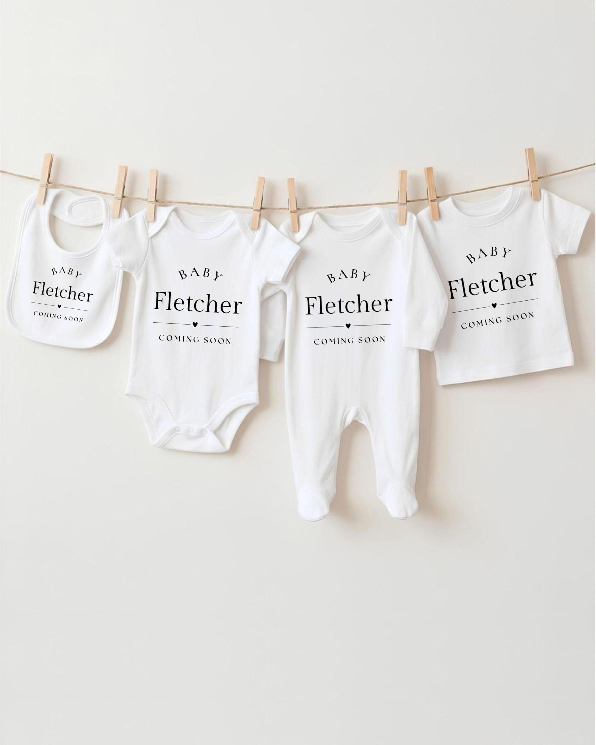 a collection of baby clothes hanging on a clothesline, each with a label that reads "BABY Fletcher" and "COMING SOON".