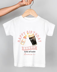 A white t-shirt with a graphic design featuring a bottle of milk and a glass of beer, along with the text "Happy Birthday Daddy Lots of Love Annie" printed on it.