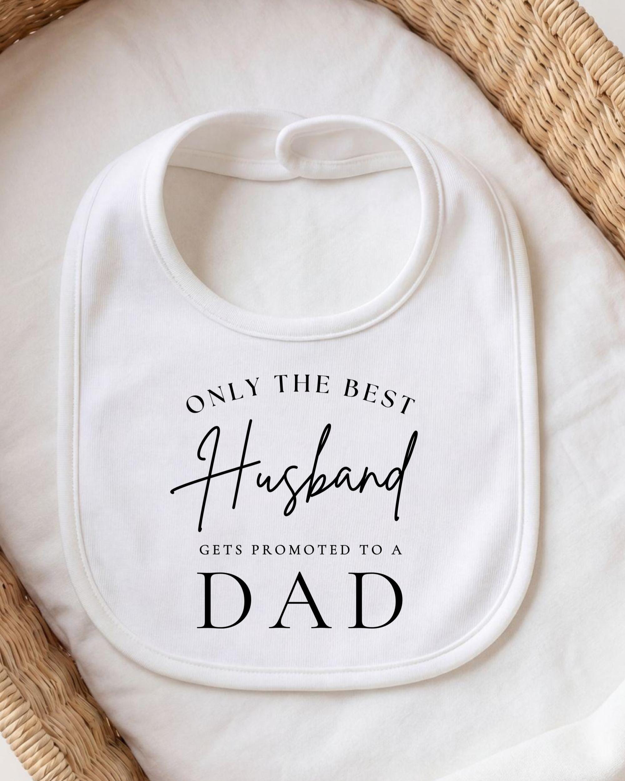 A white bib with black text that reads "ONLY THE BEST Husband gets promoted to a DAD".