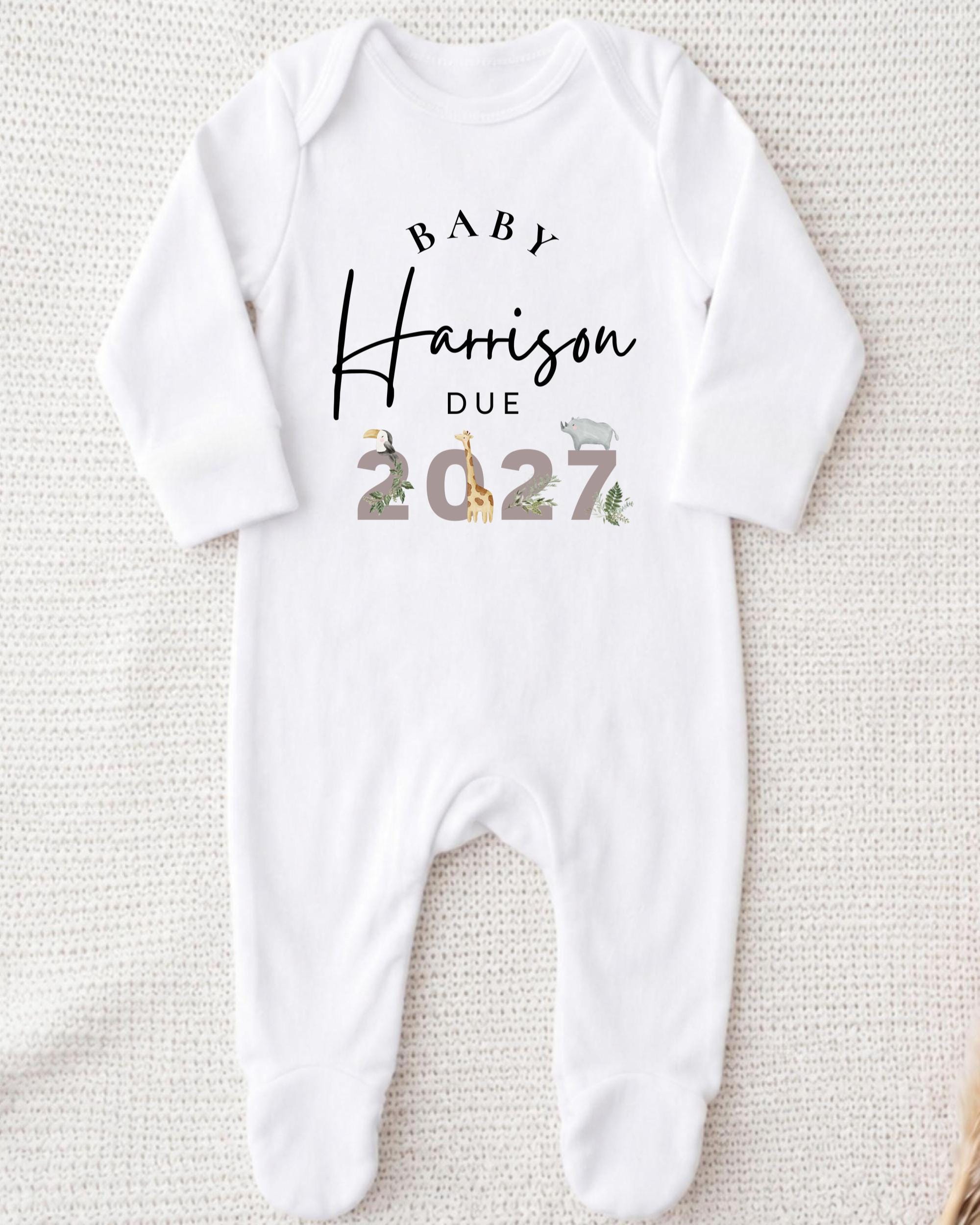 A white onesie with text and illustrations on it.