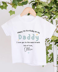 A white t-shirt with a personalized message printed on it, hanging on a wooden hanger.