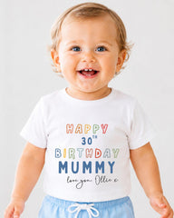 A smiling baby boy wearing a white t-shirt with text that says "Happy 30th Birthday Mummy love you. Ollie" printed on it.