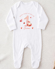 A white onesie with a personalized design on it, featuring the number 1 and the text "When I wake up I will be Zara".