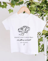 A white t-shirt with a graphic design of a couple in a car, along with text that reads "Auntie Lisa & Uncle Matt are getting married! 20.10.2021".