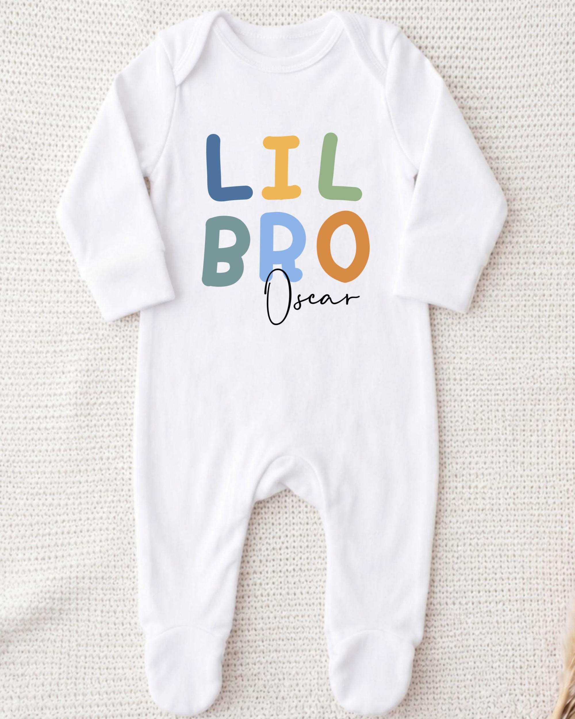 A white onesie with the text "LIL BRO Oscar" printed on it.