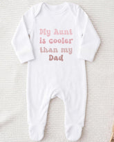 A white onesie with the text "My Aunt is cooler than my Dad" printed on it.