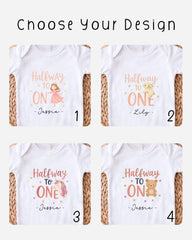 four different white t-shirts with the same design, each featuring a cartoon character and the text "Halfway to One" along with the name "Lilly" below the character.