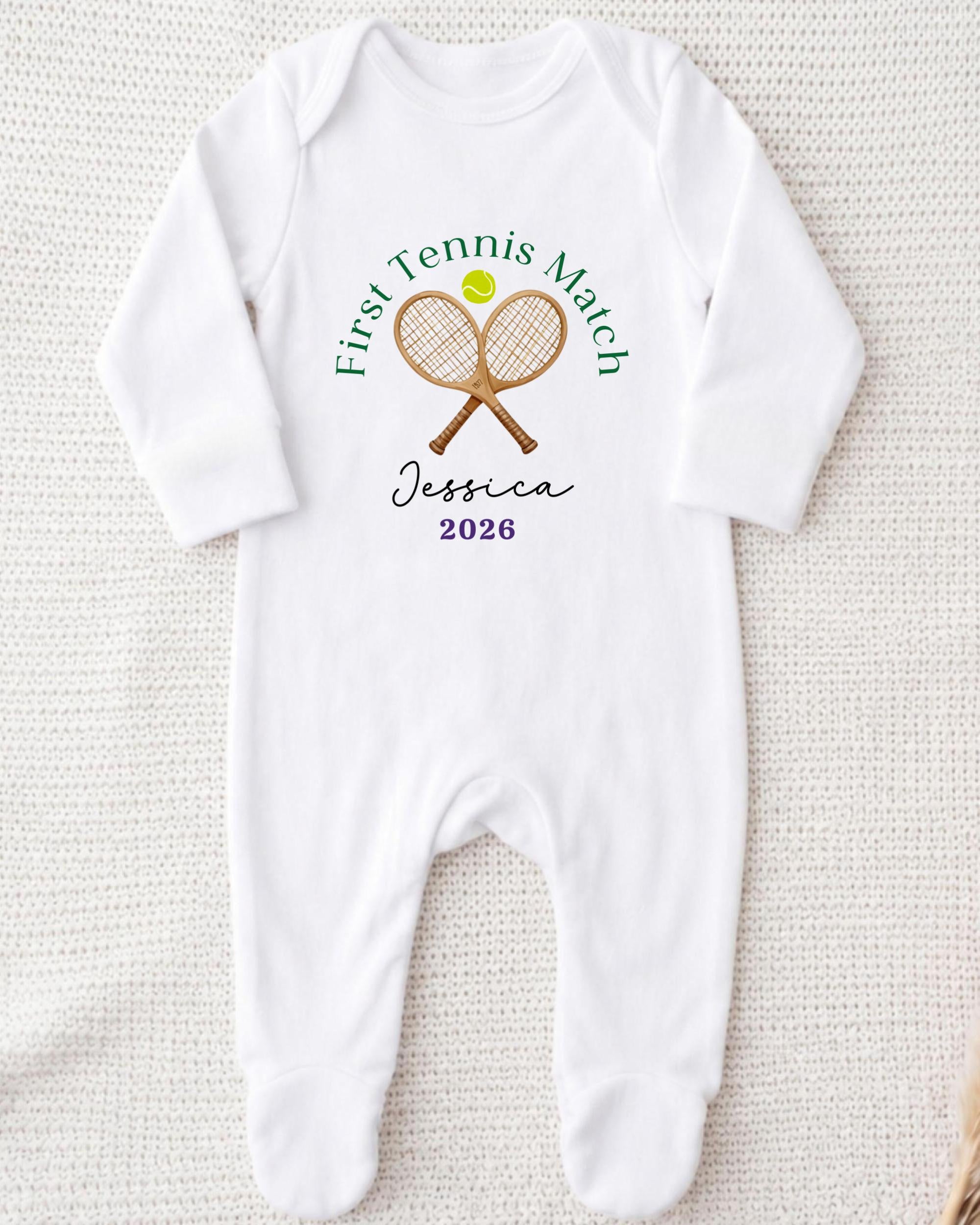 A white onesie with a tennis racket and ball design, along with the text "First Tennis Match Jessica 2016".