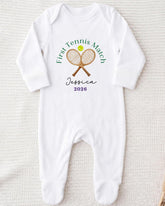 A white onesie with a tennis racket and ball design, along with the text "First Tennis Match Jessica 2016".