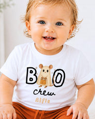 A smiling baby wearing a white t-shirt with a cartoon mouse and the text "BOO crew Alfie" printed on it.