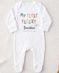 A white onesie with text and an illustration of a plane on it.
