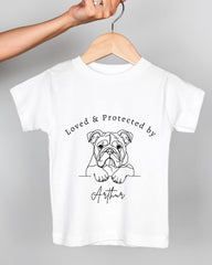 A white t-shirt with a black and white illustration of a bulldog and the text "Loved & Protected by Arthur" printed on it.