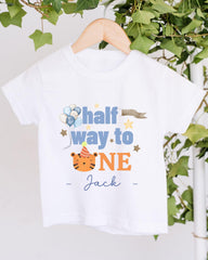 A white t-shirt with a printed design that says "half way to one" and features a tiger wearing a party hat.