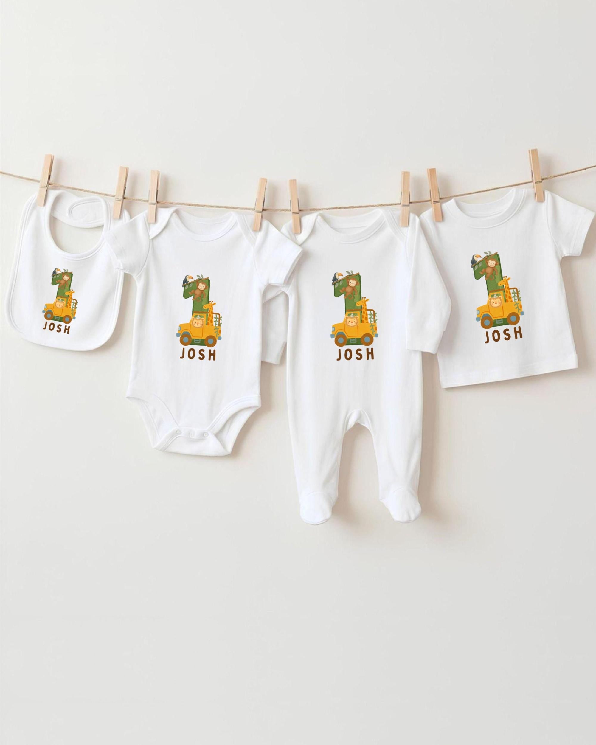 A collection of white baby clothes, including onesies and bibs, with the name " Josh" printed on them. The clothes are hanging on a clothesline, with the name " Josh" printed on each item.