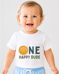 A smiling baby boy wearing a white t-shirt with a smiley face and the text "ONE HAPPY Dude" printed on it.