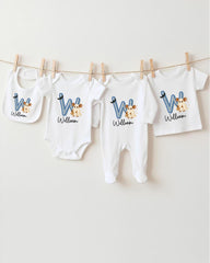 A collection of baby clothes, including onesies and bibs, hanging on a clothesline.