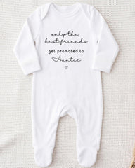 A white onesie with the text "only the best friends get promoted to Auntie" printed on it.