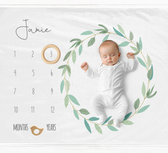 a baby laying on a calendar with a ring