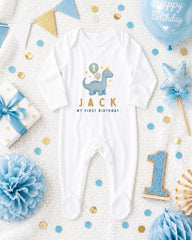 A baby's onesie with the name "Jack" printed on it, surrounded by birthday decorations such as a blue balloon, blue and gold confetti, and a blue and gold star.