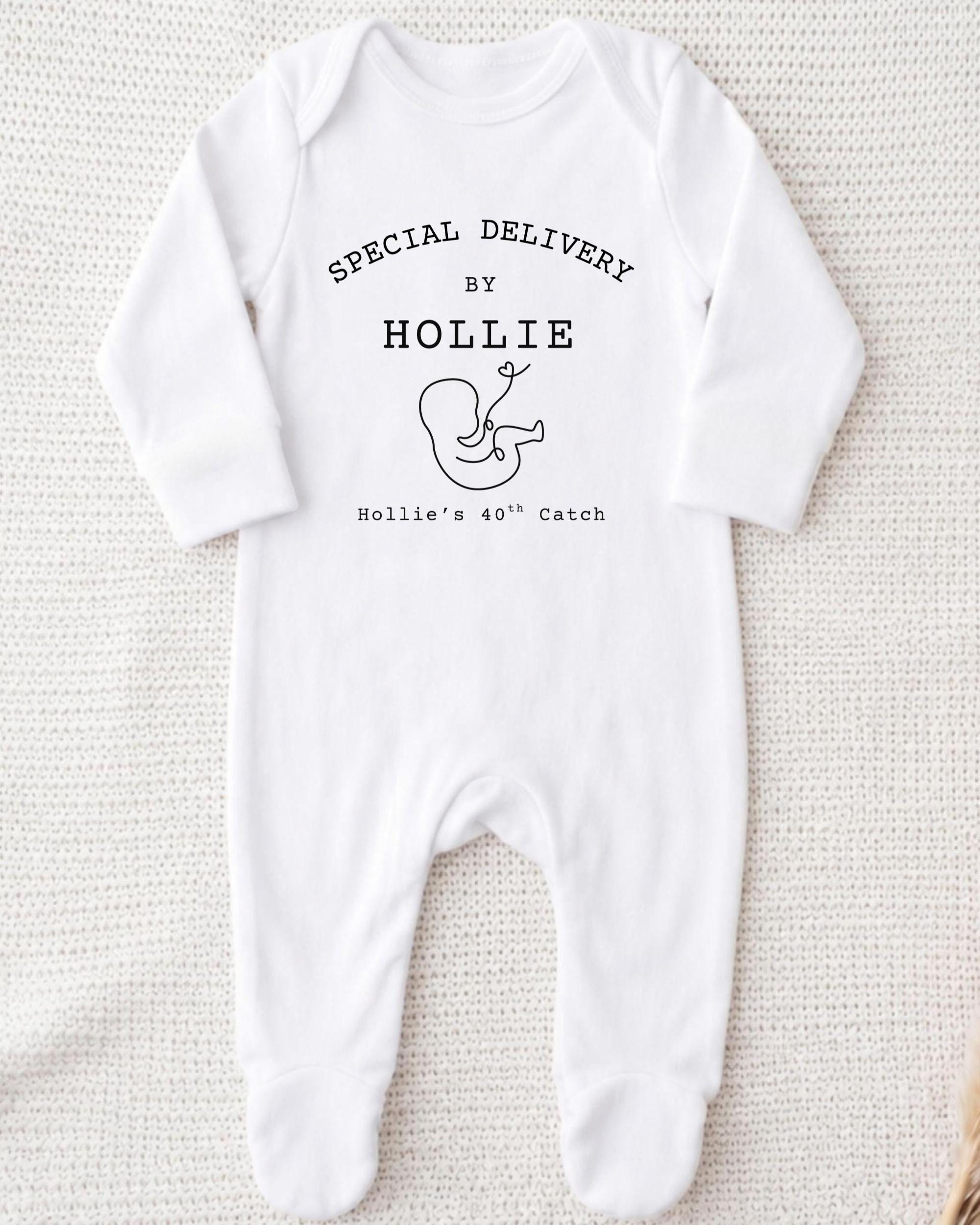 A white onesie with text and a graphic on it.