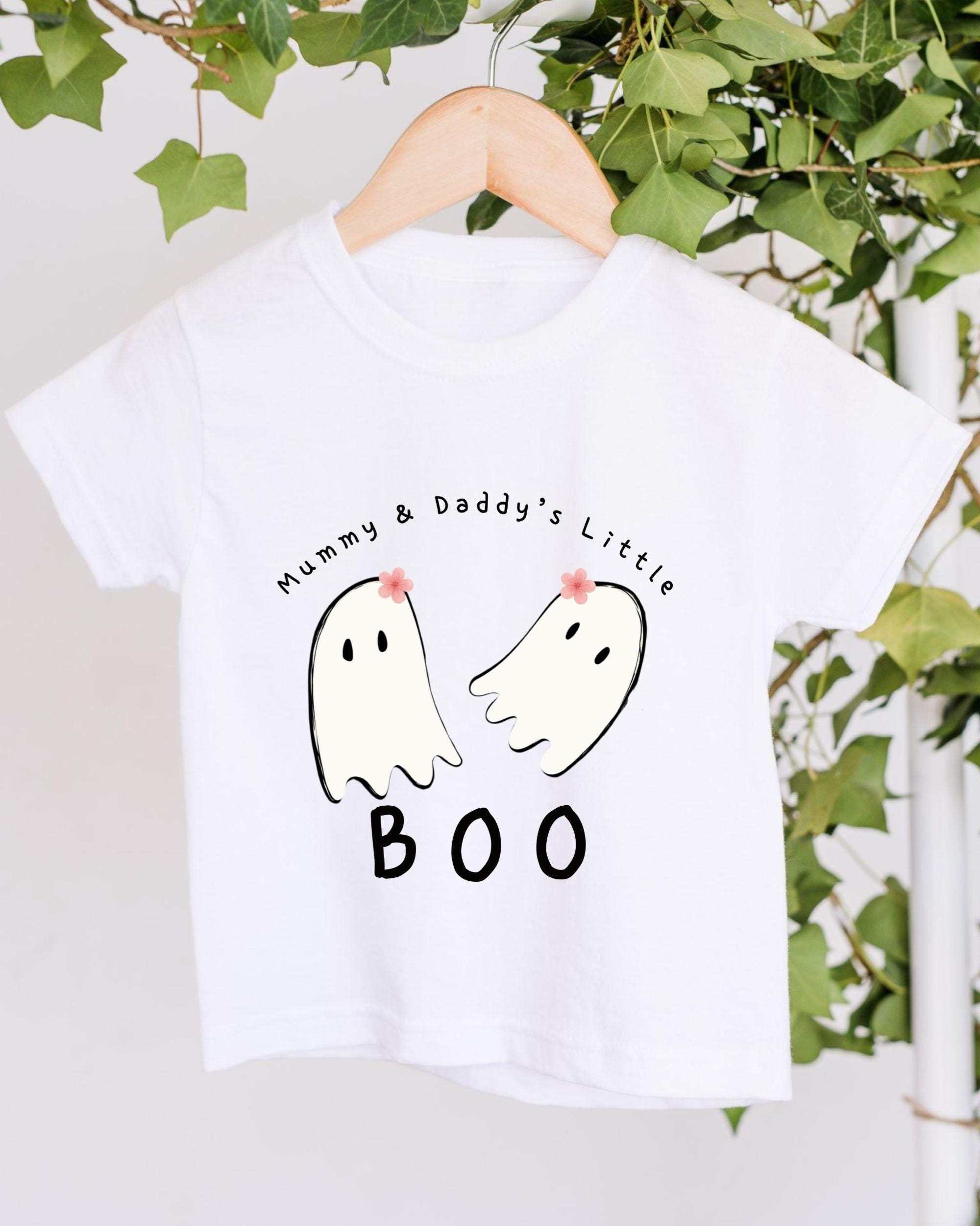 A white t-shirt with a graphic design featuring two ghost characters and the text "Mummy & Daddy's Little BOO".