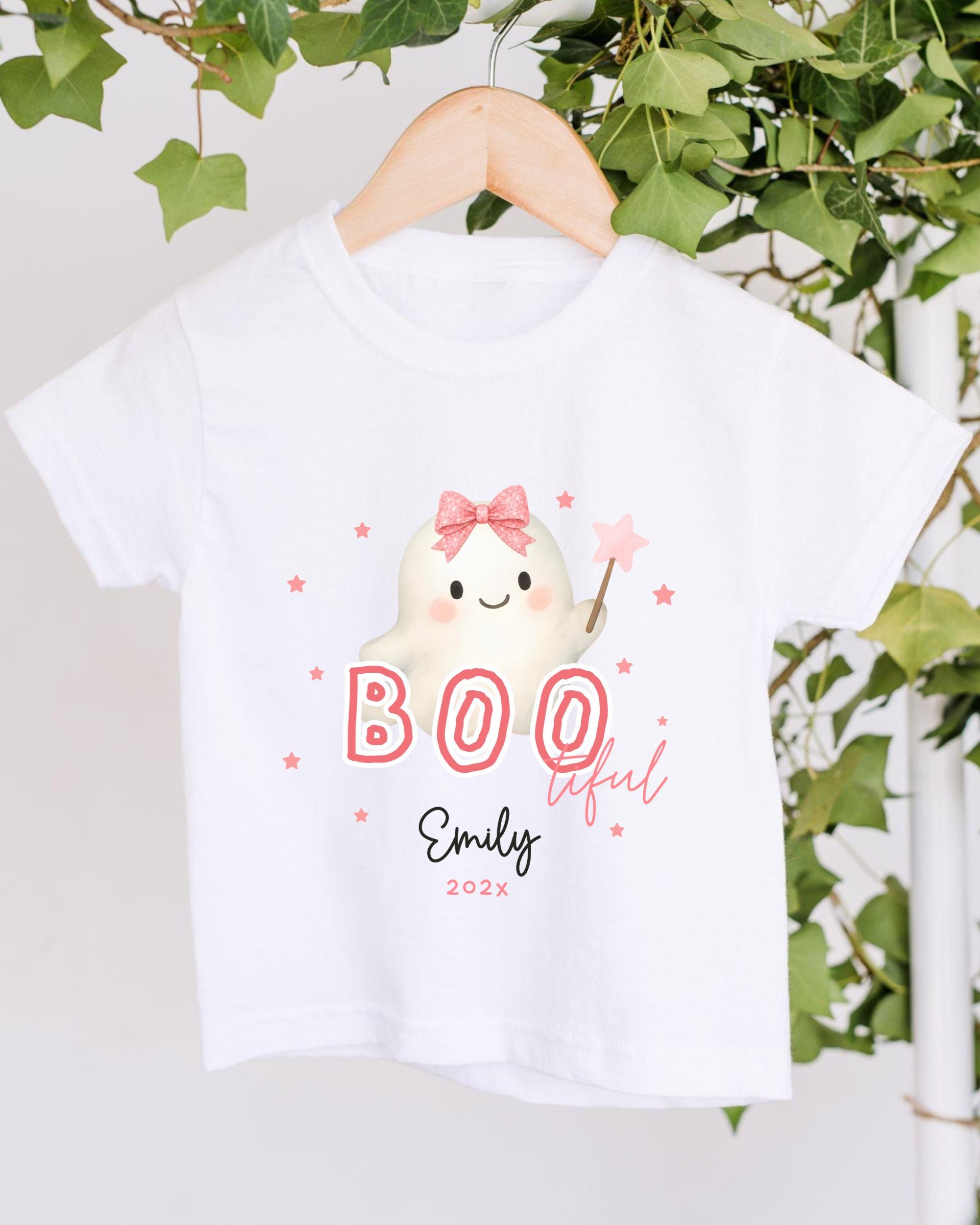 A white t-shirt with a graphic design featuring a ghost character and the text "BOO lful Emily 2020".