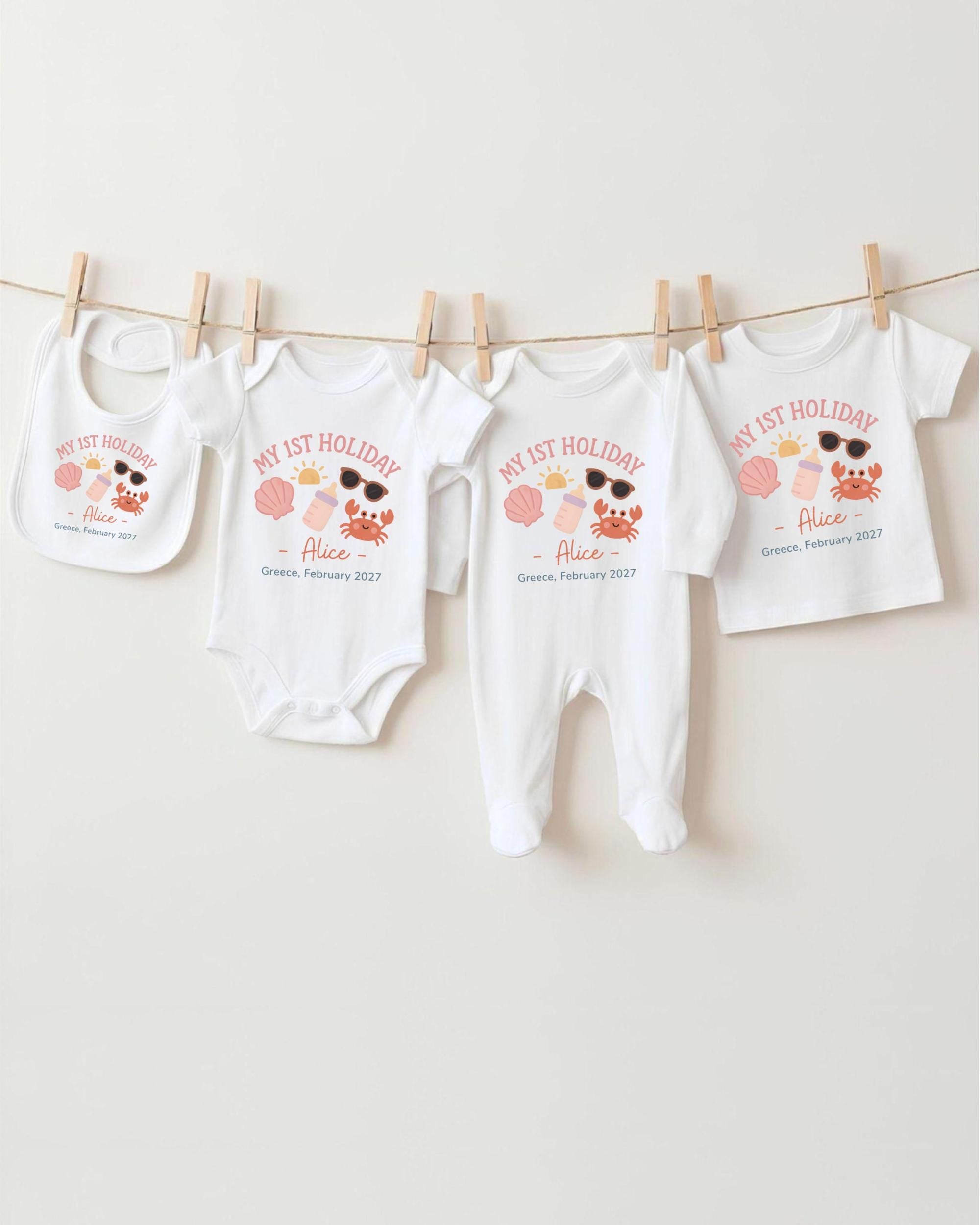 A collection of baby clothes, including onesies and bibs, hanging on a clothesline.
