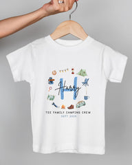 A white t-shirt with a graphic design featuring various camping-related icons and the name "Harry" written in blue.