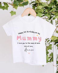 A white t-shirt with a personalized message printed on it, hanging on a wooden hanger.